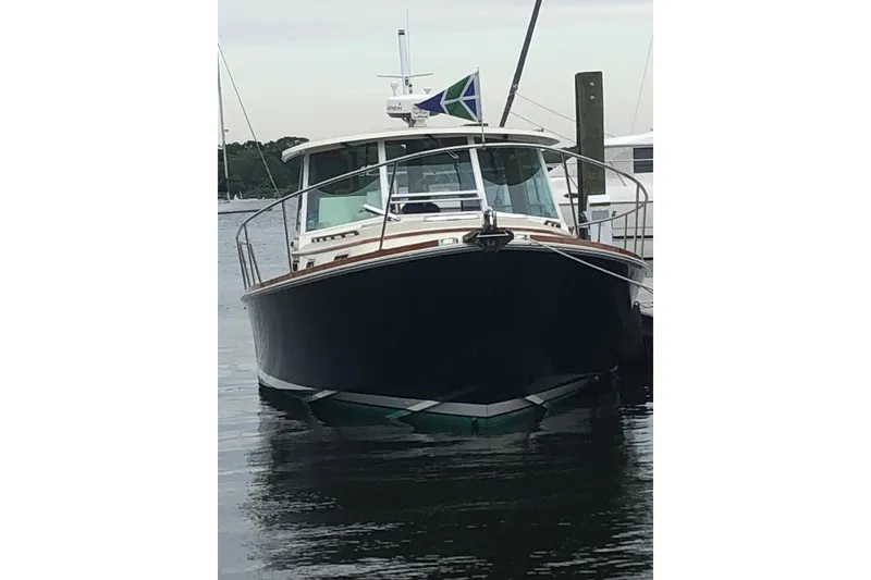 Slide: The Image of 2004 Bruckmann Bluestar 38 boat docked on calm water, front view. - 14