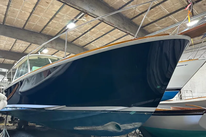 Slide: The Image of 2004 Bruckmann Bluestar 38 boat in storage, showcasing sleek design and craftsmanship. - 17