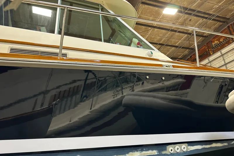 Slide: The Image of 2004 Bruckmann Bluestar 38 yacht in a warehouse, showcasing sleek design and polished finish. - 19