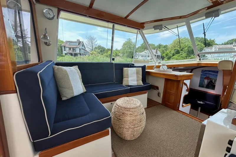 Slide: The Image of Interior of 2004 Bruckmann Bluestar 38 yacht with blue seating and wooden accents. - 26