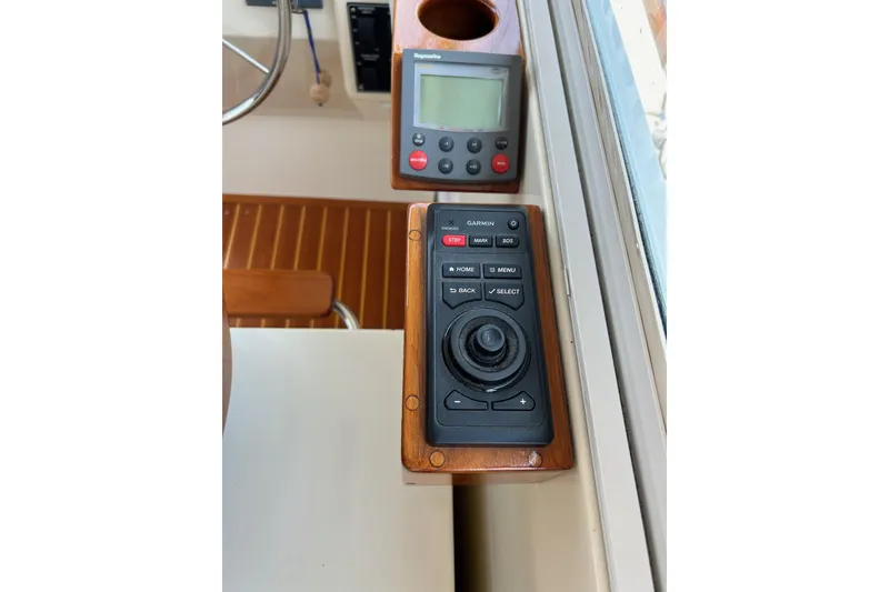 Slide: The Image of Control panel of a 2004 Bruckmann Bluestar 38 boat with Garmin and Raymarine devices. - 29