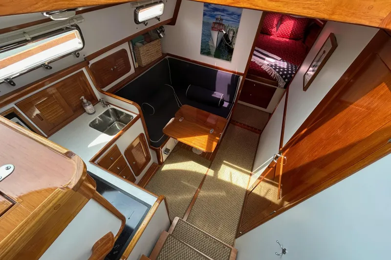 Slide: The Image of Interior of 2004 Bruckmann Bluestar 38 yacht with kitchen, seating, and cozy sleeping area. - 33
