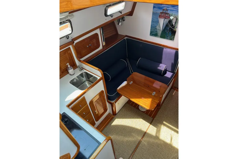 Slide: The Image of Interior of 2004 Bruckmann Bluestar 38 yacht with cozy seating and wooden finishes. - 34