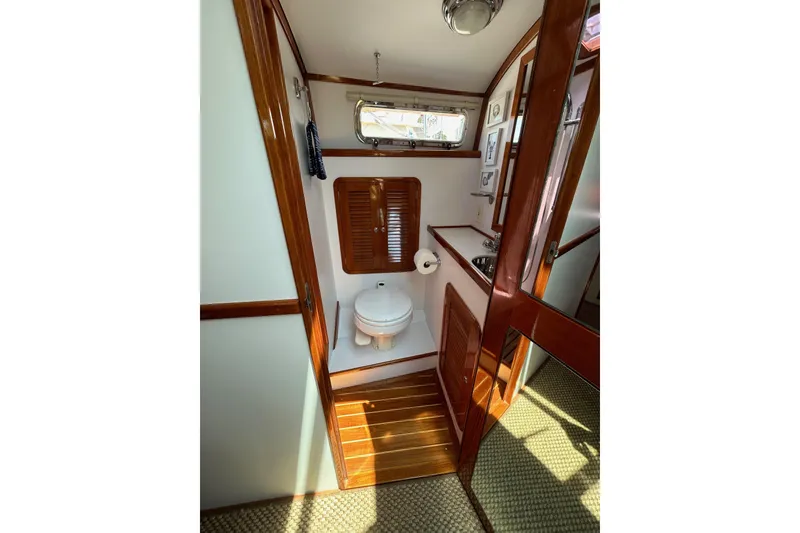 Slide: The Image of 2004 Bruckmann Bluestar 38 yacht bathroom with wooden accents and compact design. - 38
