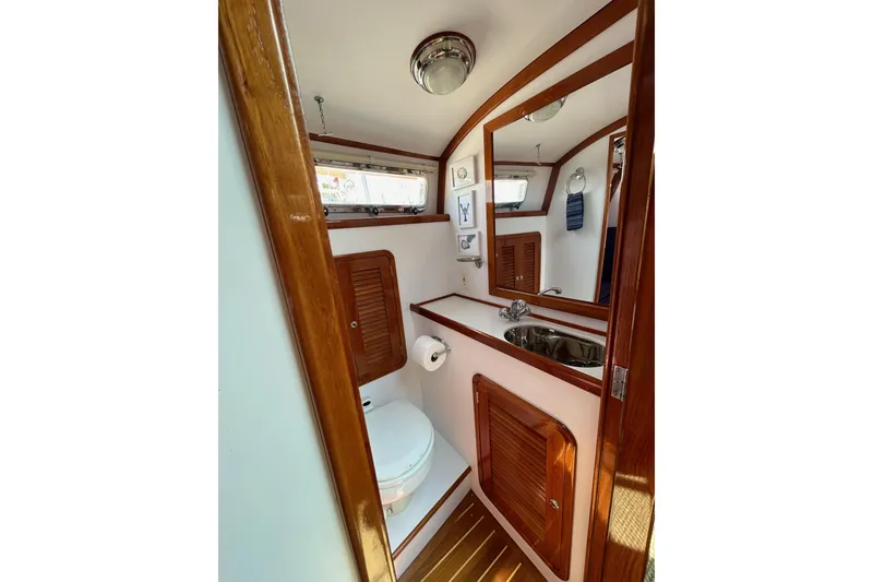 Slide: The Image of 2004 Bruckmann Bluestar 38 yacht bathroom with wooden accents and stainless steel sink. - 39