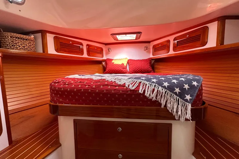 Slide: The Image of Cozy cabin interior of 2004 Bruckmann Bluestar 38 with star-patterned bedding and wooden accents. - 42