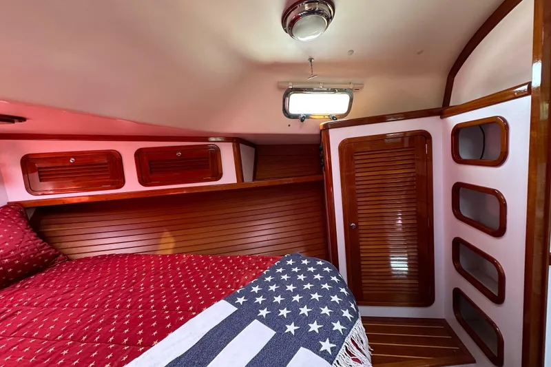Slide: The Image of Cozy cabin interior of 2004 Bruckmann Bluestar 38 with wooden accents and star-patterned bedding. - 43