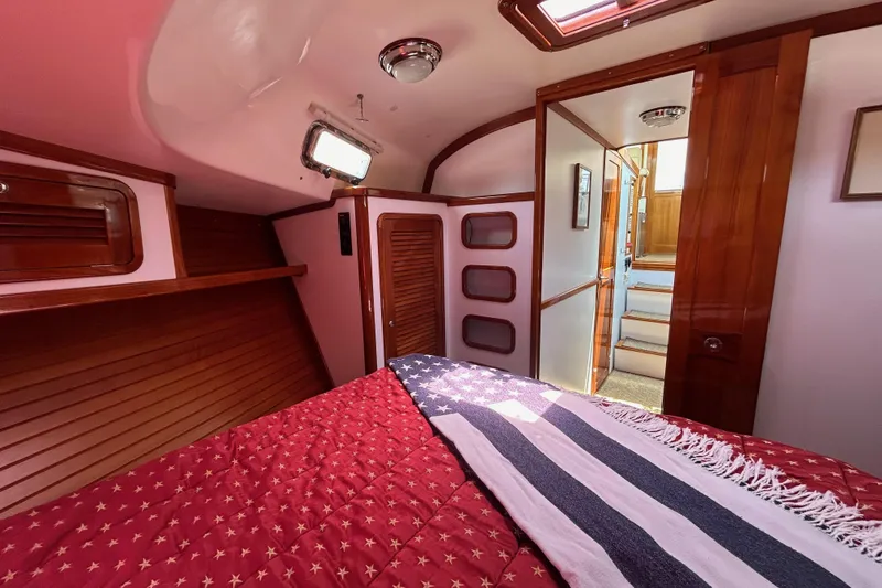 Slide: The Image of Cozy cabin interior of 2004 Bruckmann Bluestar 38 with wooden accents and star-patterned bedding. - 45