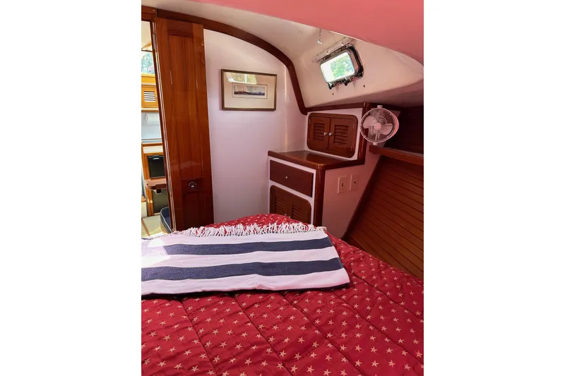 Slide: The Image of Cozy cabin interior of 2004 Bruckmann Bluestar 38 with red bedding and nautical decor. - 46