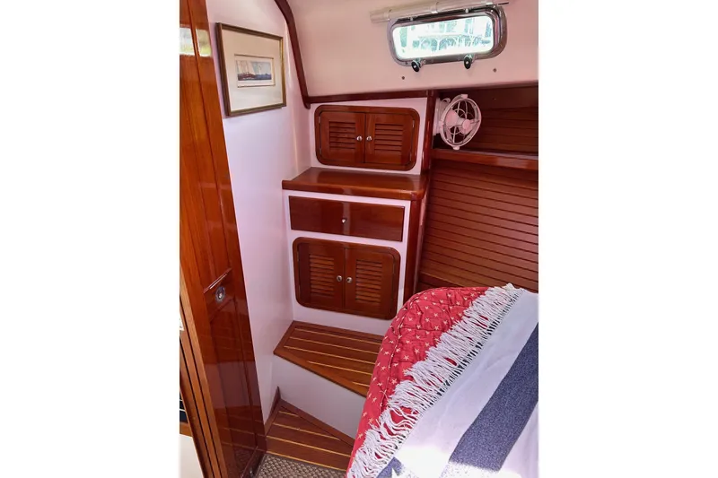 Slide: The Image of Interior of 2004 Bruckmann Bluestar 38 with wooden cabinetry and cozy bedding. - 47