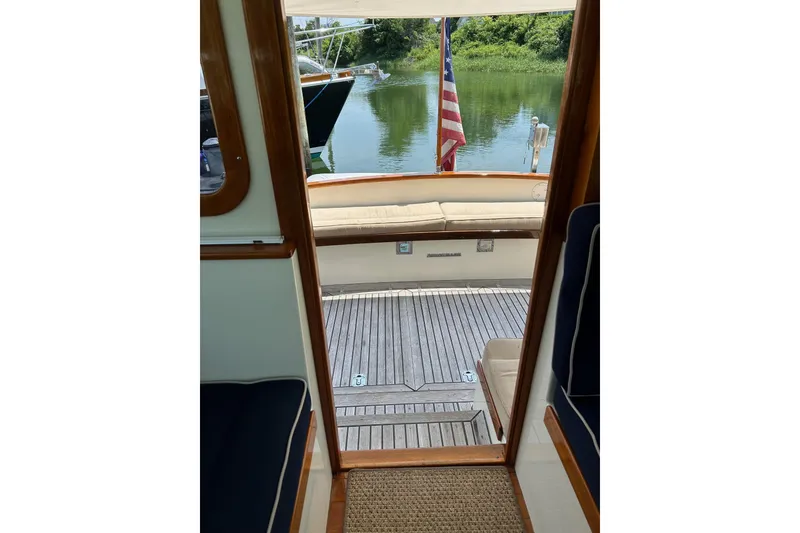 Slide: The Image of Interior view of 2004 Bruckmann Bluestar 38 yacht, featuring wooden deck and seating area. - 48
