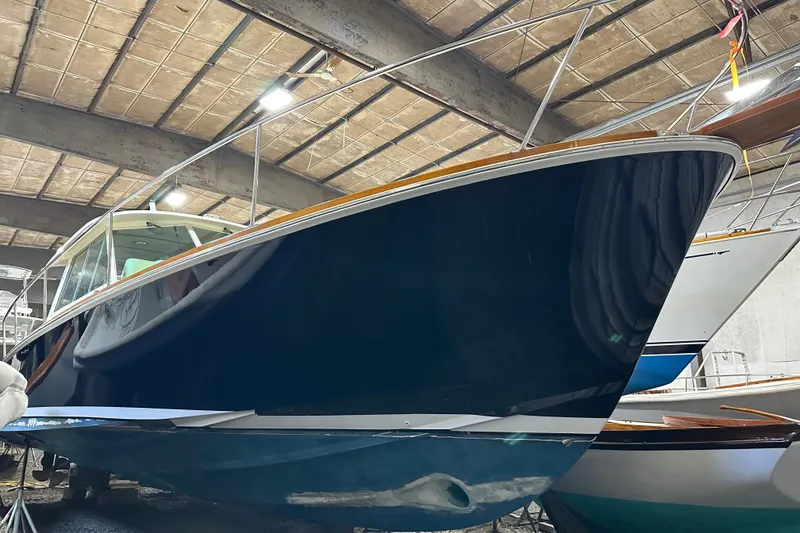 Slide: The Image of 2004 Bruckmann Bluestar 38 yacht in storage, showcasing sleek design and polished hull. - 6