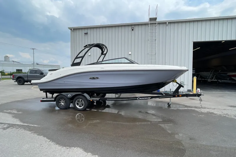 The Image of 2023 Sea Ray SPX 230 boat on trailer outside a warehouse. - 0