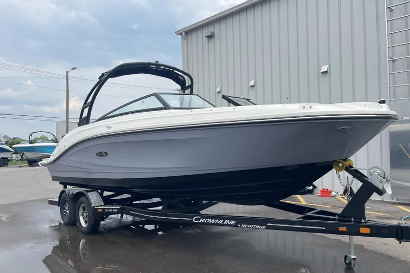 Slide: The Image of 2023 Sea Ray SPX 230 boat on trailer, parked outside a building. - 3