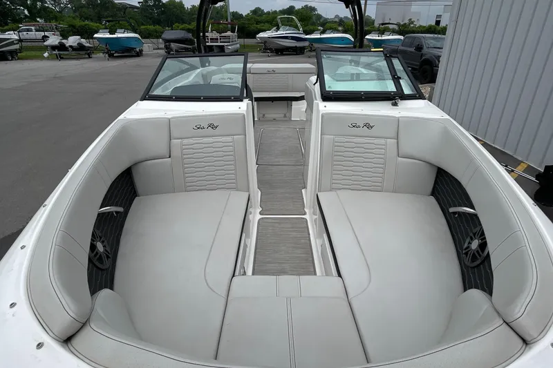 Slide: The Image of 2023 Sea Ray SPX 230 boat interior with white seating and open deck layout. - 5