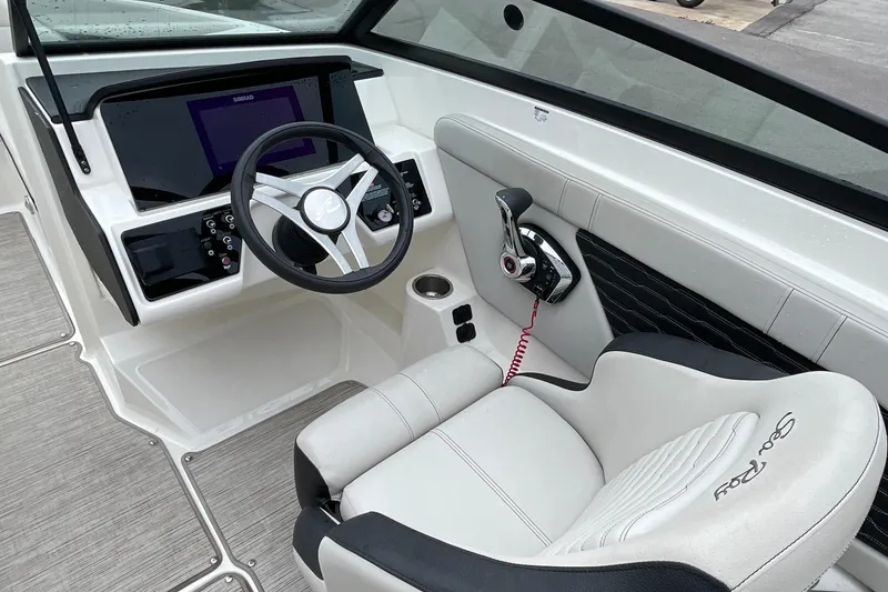 Slide: The Image of Interior of 2023 Sea Ray SPX 230 boat, featuring steering wheel and control panel. - 7