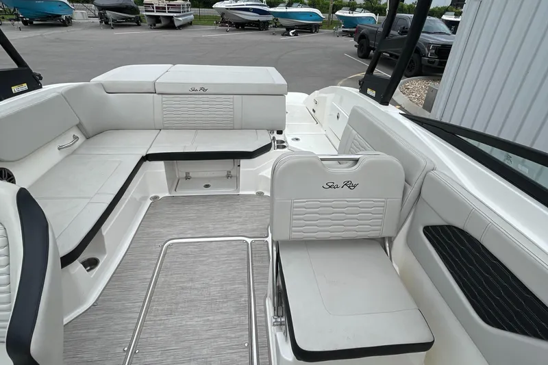 Slide: The Image of 2023 Sea Ray SPX 230 boat interior with white seating and sleek design. - 8