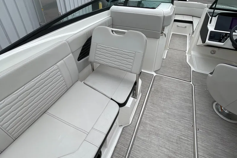 Slide: The Image of 2023 Sea Ray SPX 230 boat interior with gray seating and flooring. - 9