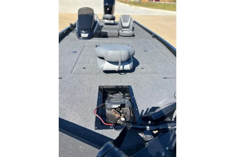 Slide: The Image of 2025 Lowe Stinger 195 Bass boat interior with open storage compartment and seating. - 2