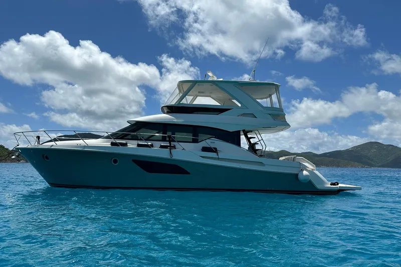 The Image of 2020 Tiara Yachts F53 Flybridge on clear blue water under a bright sky. - 0