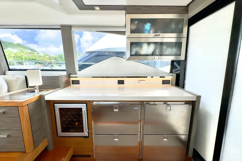 Slide: The Image of Modern kitchen area in a 2020 Tiara Yachts F53 Flybridge, featuring sleek cabinetry and appliances. - 10