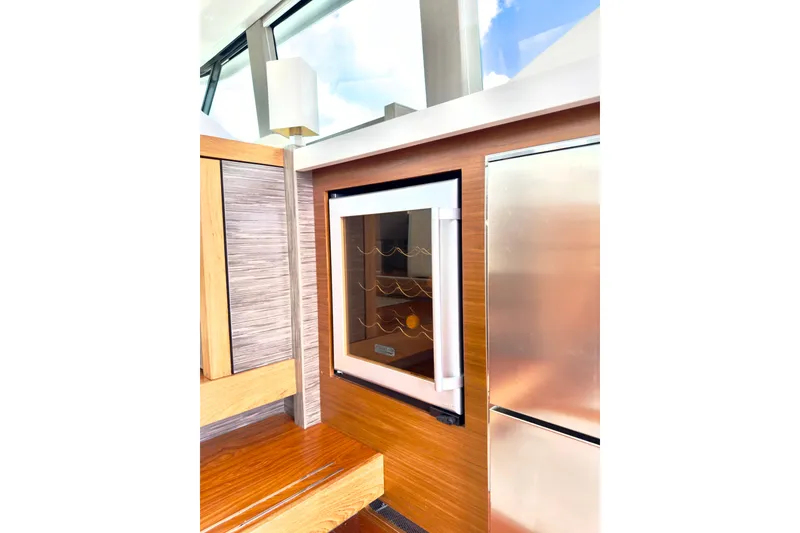 Slide: The Image of 2020 Tiara Yachts F53 Flybridge interior with modern cabinetry and built-in wine cooler. - 11