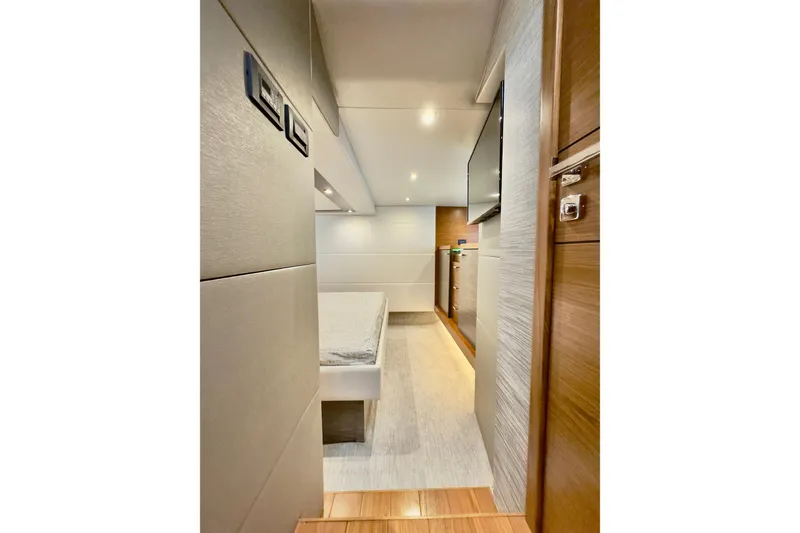 Slide: The Image of 2020 Tiara Yachts F53 Flybridge interior cabin with modern design and wood accents. - 12