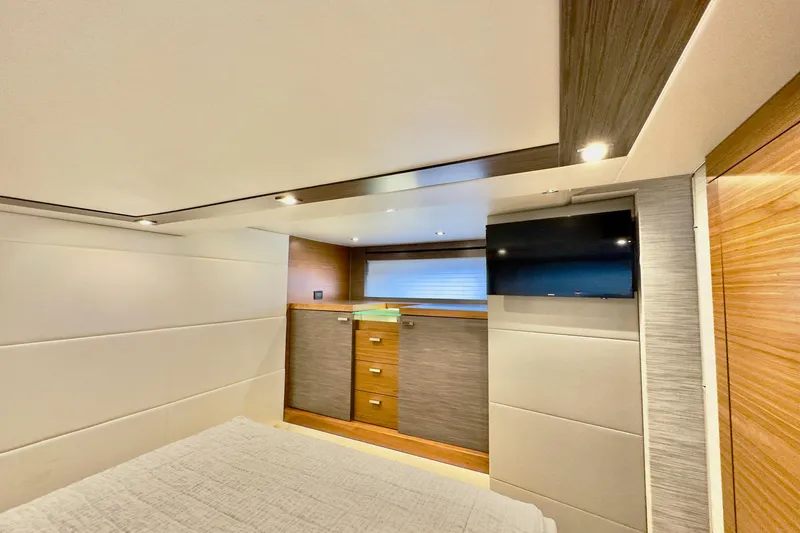 Slide: The Image of Luxurious interior of 2020 Tiara Yachts F53 Flybridge with modern cabinetry and wall-mounted TV. - 15