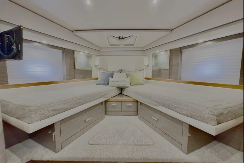 Slide: The Image of Luxurious 2020 Tiara Yachts F53 Flybridge cabin interior with twin beds and modern decor. - 19