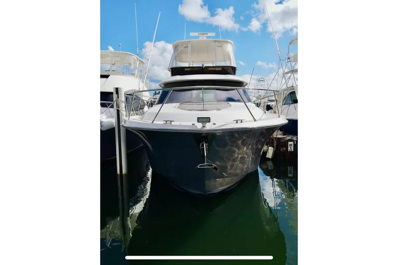 Slide: The Image of 2020 Tiara Yachts F53 Flybridge docked, showcasing sleek design and modern features. - 2