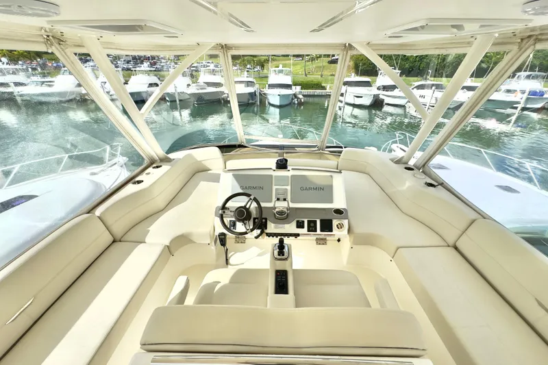Slide: The Image of 2020 Tiara Yachts F53 Flybridge helm with Garmin navigation, docked in marina. - 23