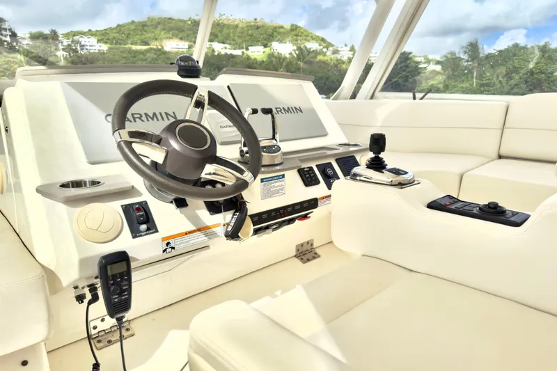 Slide: The Image of 2020 Tiara Yachts F53 Flybridge helm with Garmin navigation and luxurious seating. - 26