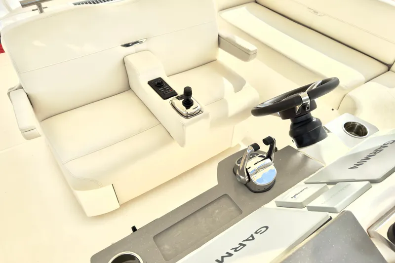 Slide: The Image of 2020 Tiara Yachts F53 Flybridge helm with steering wheel and controls. - 27