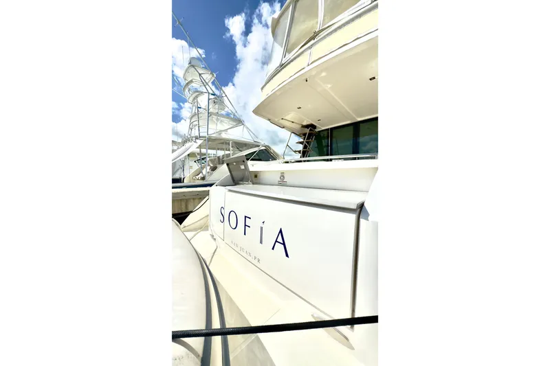 Slide: The Image of 2020 Tiara Yachts F53 Flybridge, docked with "Sofía" name visible, under blue sky. - 4