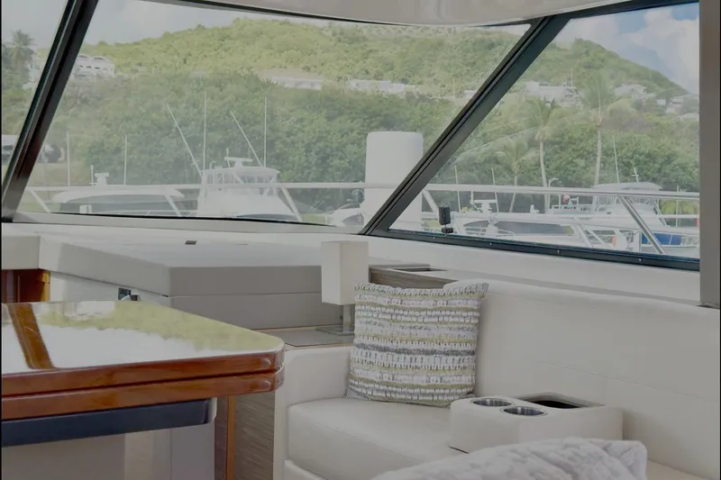 Slide: The Image of Interior view of 2020 Tiara Yachts F53 Flybridge, featuring elegant seating and scenic marina backdrop. - 8