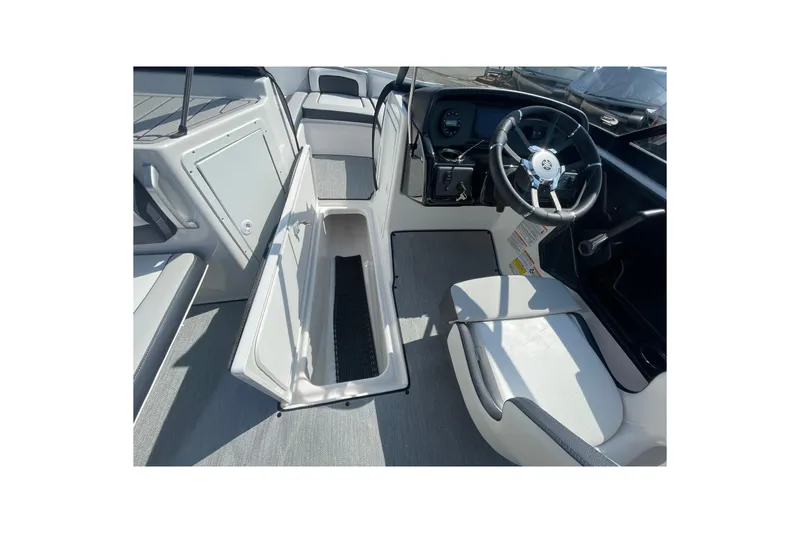 Slide: The Image of 2026 Yamaha Boats AR195 interior with open storage compartment and steering wheel. - 13