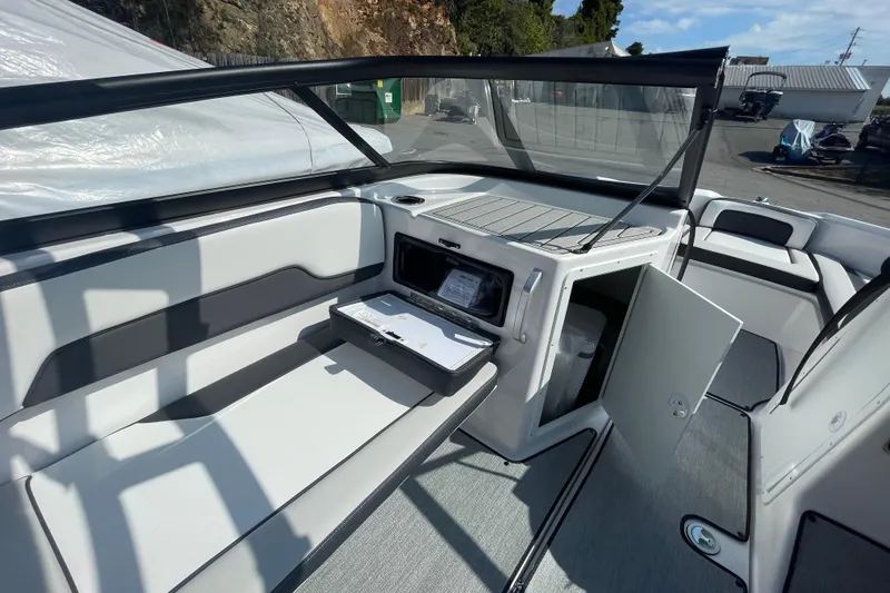 Slide: The Image of 2026 Yamaha Boats AR195 interior with open storage compartments and seating area. - 14