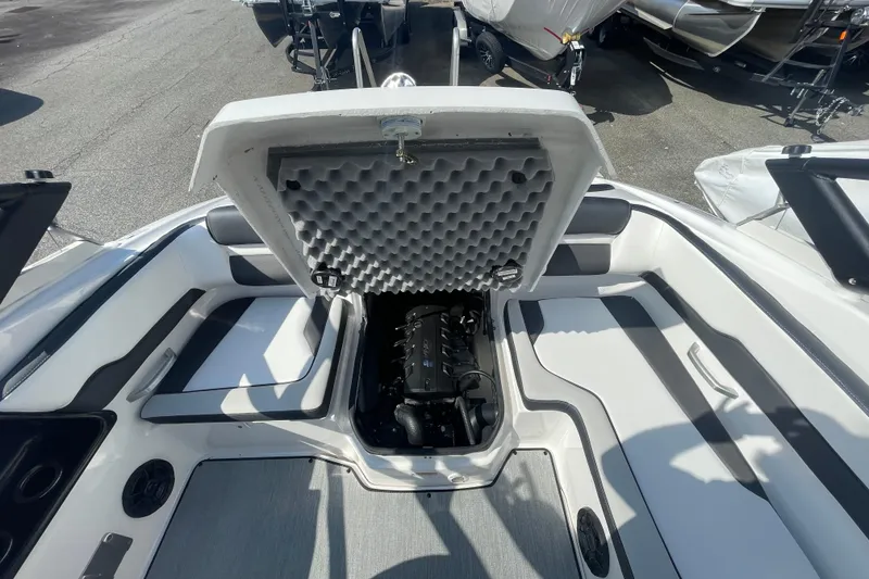 Slide: The Image of 2026 Yamaha Boats AR195 engine compartment with open hatch, showcasing interior design. - 16