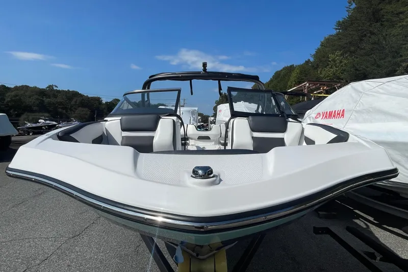 Slide: The Image of 2026 Yamaha Boats AR195, sleek white design, parked outdoors under clear blue sky. - 19