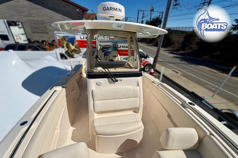 Slide: The Image of 2023 Grady-White Canyon 271 boat interior with Garmin equipment, displayed outdoors. - 4