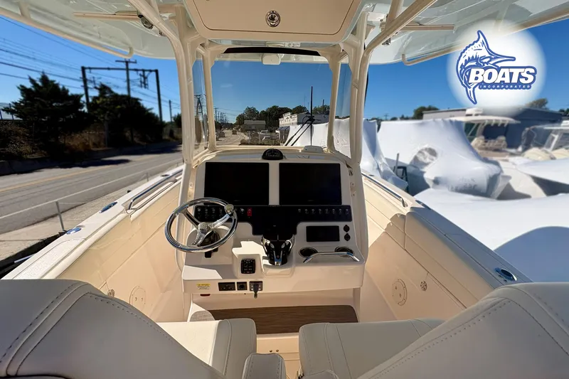 Slide: The Image of 2023 Grady-White Canyon 271 boat cockpit with steering wheel and control panel. - 7