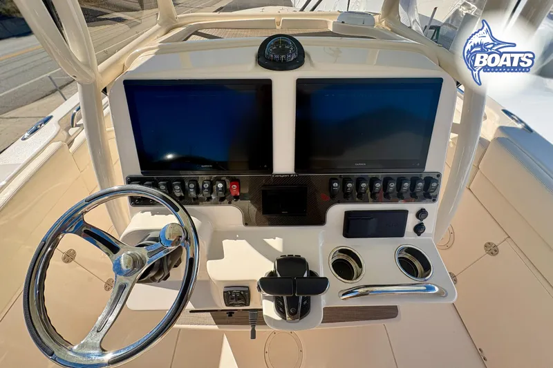 Slide: The Image of 2023 Grady-White Canyon 271 boat dashboard with dual screens and steering wheel. - 8
