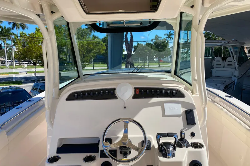 Slide: The Image of 2026 Grady-White Canyon 336 helm with modern controls and panoramic view. - 12