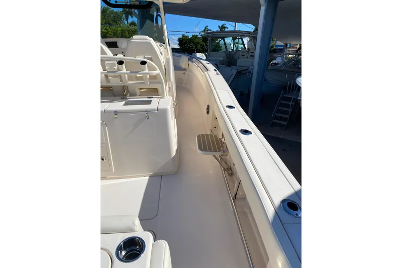 Slide: The Image of 2026 Grady-White Canyon 336 boat interior, featuring seating and rod holders. - 14