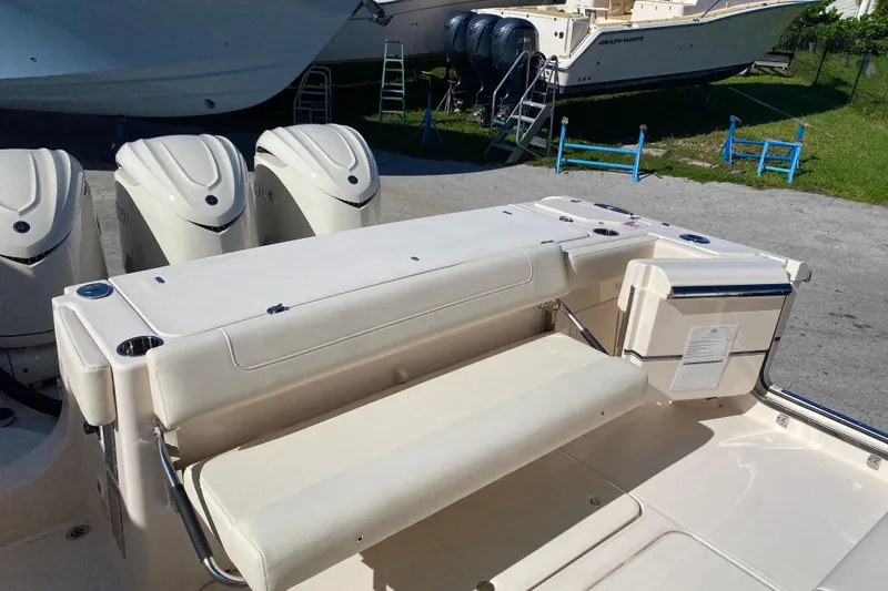 Slide: The Image of 2026 Grady-White Canyon 336 boat with triple outboard engines and spacious seating area. - 15