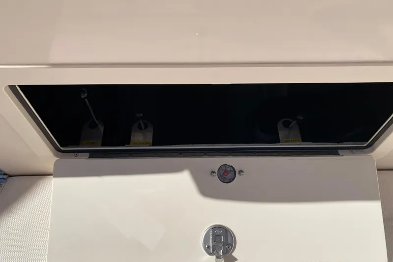 Slide: The Image of 2026 Grady-White Canyon 336 storage compartment with latch and shadow detail. - 18