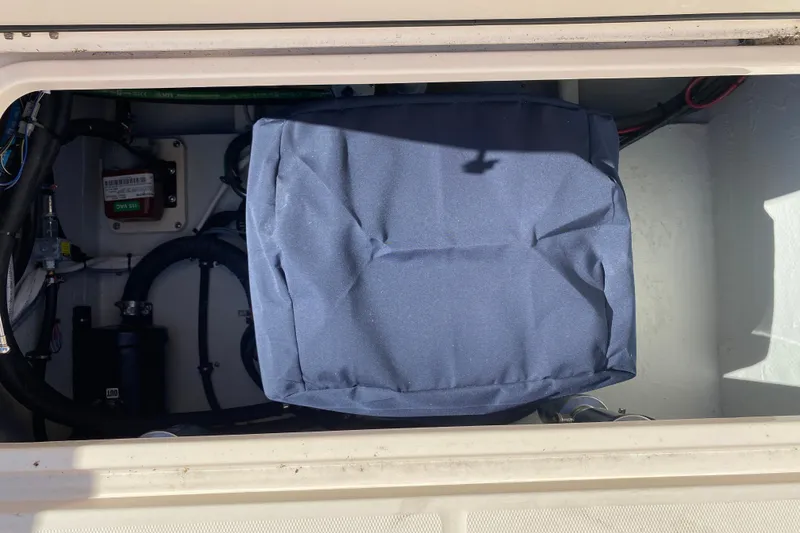 Slide: The Image of 2026 Grady-White Canyon 336 boat compartment with covered equipment and wiring. - 19