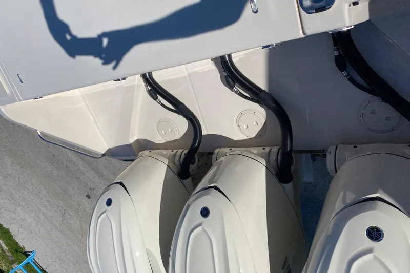Slide: The Image of 2026 Grady-White Canyon 336 boat with triple outboard engines, viewed from above. - 20