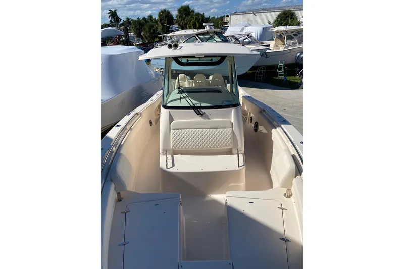 Slide: The Image of 2026 Grady-White Canyon 336 boat, spacious deck, luxurious seating, marina background. - 3