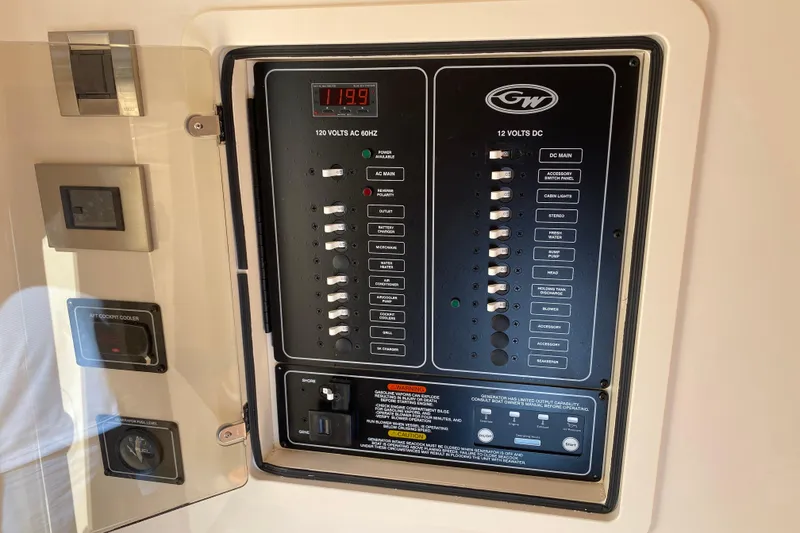 Slide: The Image of Electrical control panel on 2026 Grady-White Canyon 336 boat, showing AC and DC switches. - 9